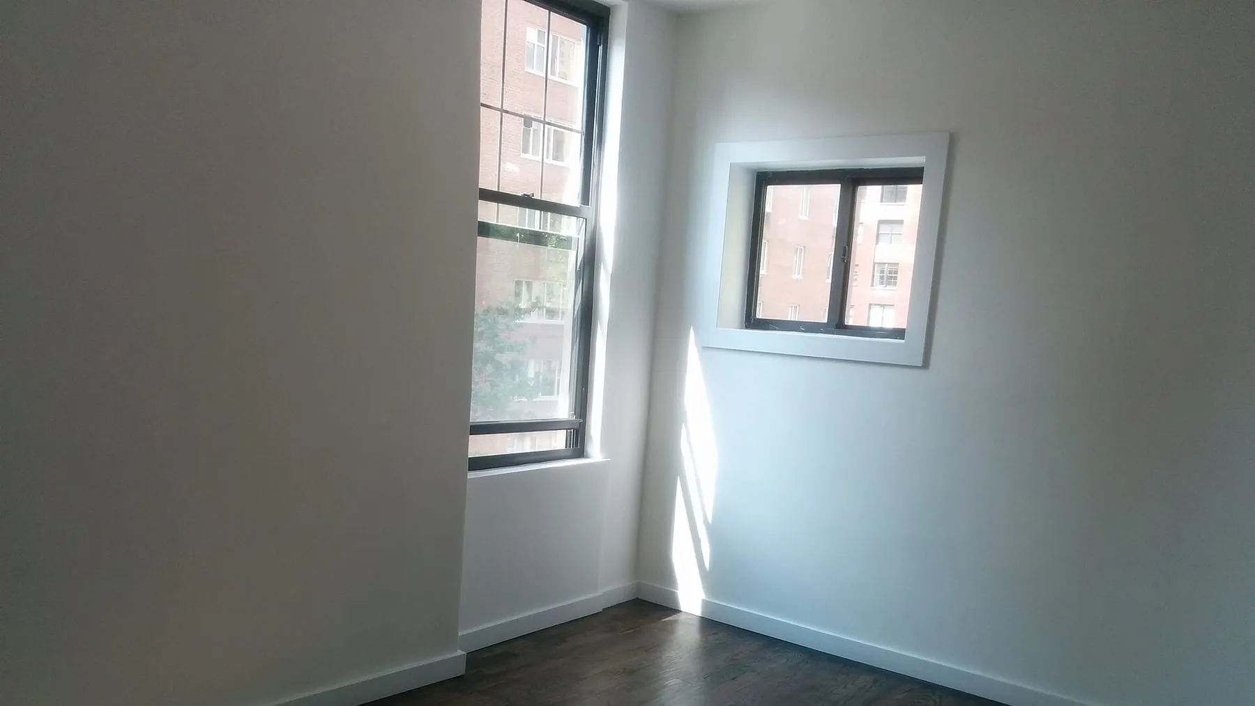 The empty second floor, windows open, the space where the beds will stand.